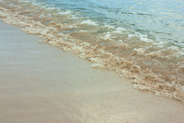 Soft wave of blue ocean on sandy beach. Background