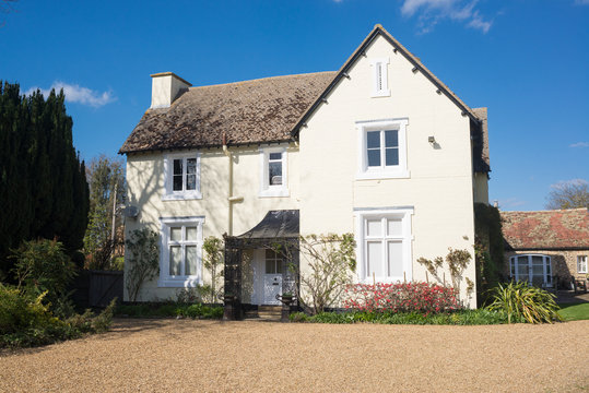 White traditional British country house with bigvgravel yard at the front in England, UK