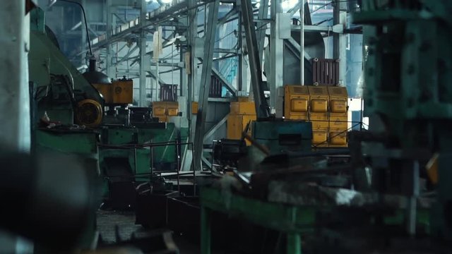 Close-up of wrench near industrial machines in a old factory. Industrial workshop.