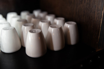 Many white salt shakers in a bar restaurant and pub