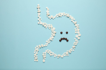 Stomach of tablets, sad face. Gastritis and digestive problems, ulcers.
