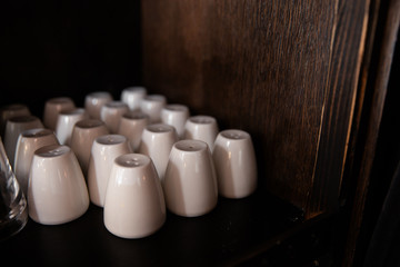 Many white salt shakers in a bar restaurant and pub