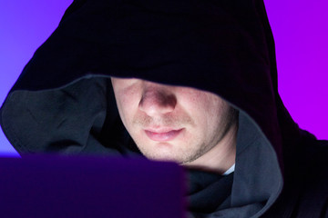 Closeup photo handsome man working on laptop anonymously