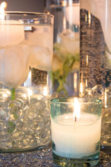 Floating candles and roses in water at a wedding