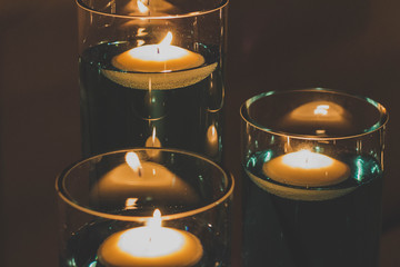 Floating candles in blue water at a wedding