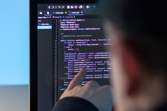 Programmer working on laptop computer in office