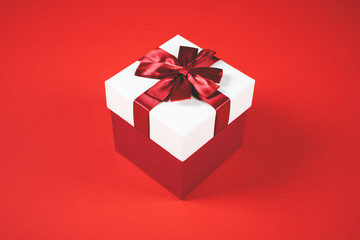 Beautiful present box on red background.