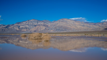 Fototapeta na wymiar death valley during a rare flood in a dry lake bed, near the Panamint mountains, March 2019.