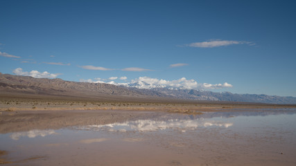 Fototapeta na wymiar Dry lake beds in Death Valley come to life with water and flood in the winter of 2018 