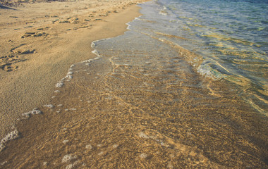 idyllic yellow sand beach and soft blue shoreline water waves in summer vacation conceptual photography outdoor natural wilderness landscape simple background wallpaper pattern with empty copy space 