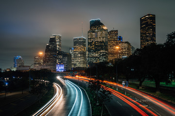 Fototapeta na wymiar Long exposure of traffic on Allen Parkway and the Houston skyline at night, in Houston, Texas