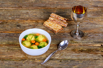 Hot Homemade Matzo Ball Soup in a Bowl Passover wine and matzah