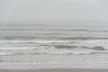 Fototapeta na wymiar Waves in the Gulf of Mexico on a cloudy day in Galveston, Texas