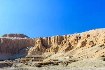 Fototapeta premium View on a temple of Hatshepsut under the high cliffs in Luxor, Egypt
