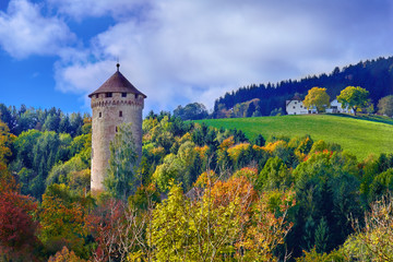 Old medieval castle tower on a hill in the forest in Europe on a bright sunny day - 258814438