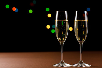 Champagne glasses on black background. Holiday celebration concept.
