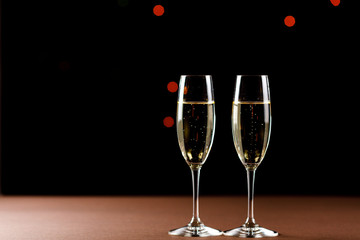 Champagne glasses on black background. Holiday celebration concept.