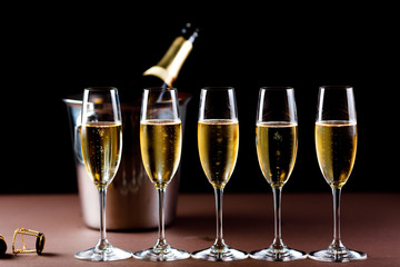 glasses of champagne on black  background with bokeh circles. Place for text.