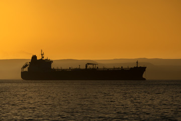 Fototapeta premium a Tanker waits of shore in La Paz Mexico to provide fuel for the local electric plant.