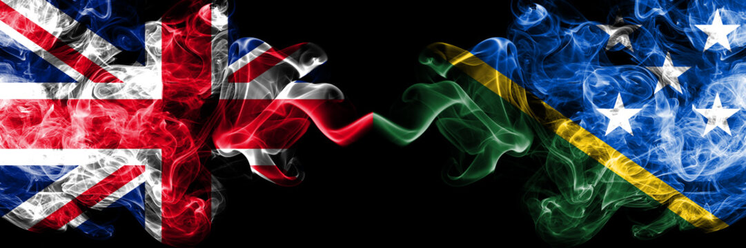 United Kingdom vs Solomon Islands smoky mystic flags placed side by side. Thick colored silky smoke flags of Great Britain and Solomon Islands.