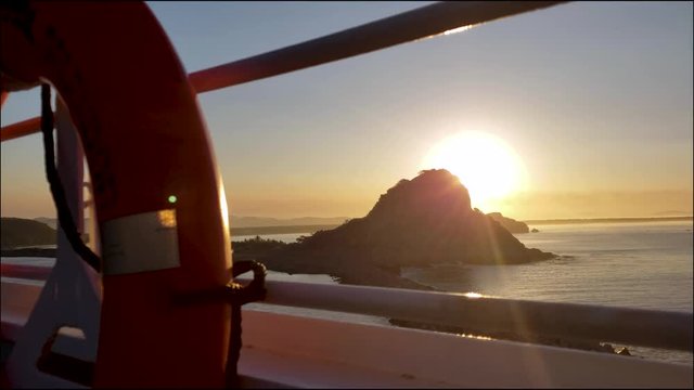 Cruise Moving Alongside Island at Sunrise