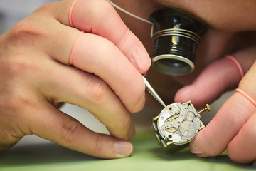 Macro close up of unrecognizable man repairing mechanical watch, copy space