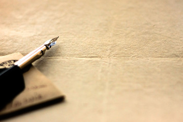 Old lettering background. Quill pen and blank sheet of paper. Copy space.