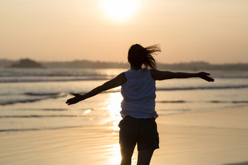 Fototapeta premium Happy Free Woman at Sunset on the Beach