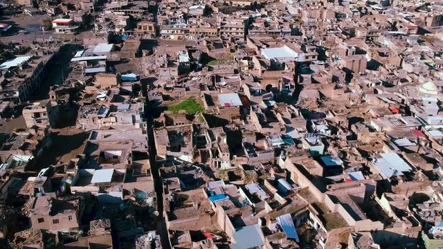 Drone down to up aerial tilt of Mosul city after the military operation against ISIL.