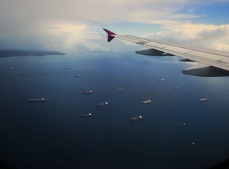 Fototapeta na wymiar airplane flying above the ships