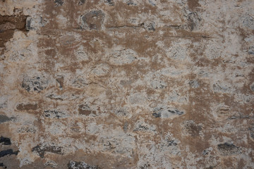 Old stone wall texture. Ancient beige and white stones. 