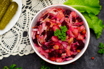 salad vinaigrette next to greens, proper nutrition, vegetarian, selective focus on wooden background