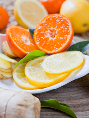 Fototapeta na wymiar Citrus - Lemon, lime, mandarine and ginger fresh slices for a delicious drink.