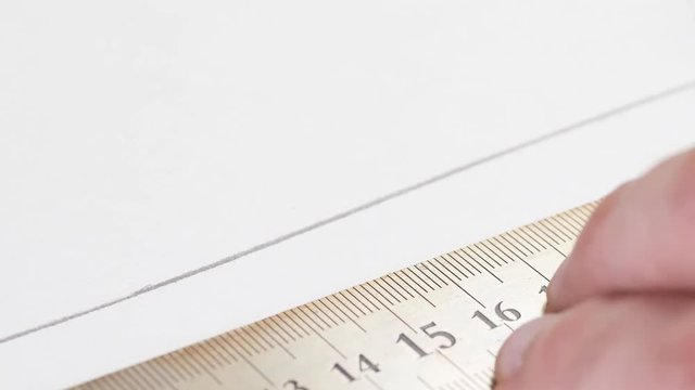 Wooden pencil tracing a line on a white piece of paper. macro shot.