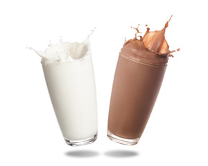 Milk and chocolate milk splashing out of glass isolated on white background.