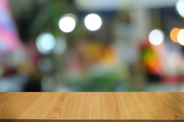 Empty dark wooden table in front of abstract blurred bokeh background of restaurant . can be used for display or montage your products.Mock up for space.