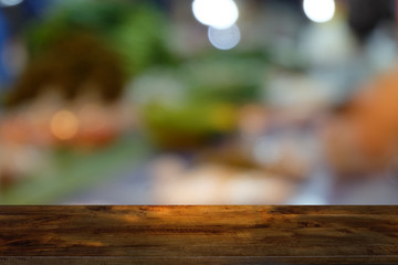 Empty dark wooden table in front of abstract blurred bokeh background of restaurant . can be used for display or montage your products.Mock up for space.