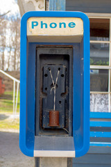 An out-of-service payphone has been equiped with older communication technology