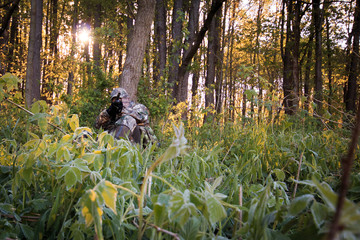 Turkey Hunting in spring with sunrise through trees