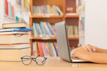 In the library - Young girl student with books working in a high school library.