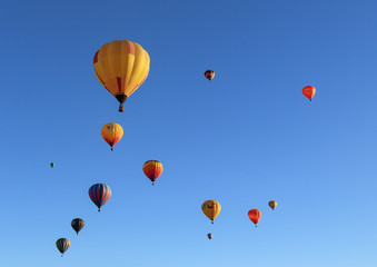 Colorful hot air balloons against a blue sky background