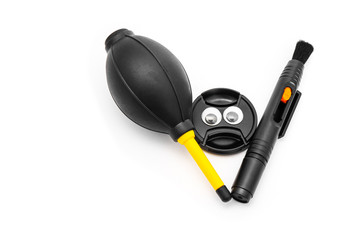 Lens Cover Face with Googly Eyes and Camera Cleaning Set Isolated on a White Background with Clipping Path. Closeup Lens Pen, Blower Brush and Lens Cover Black Color Tool for Photographic Equipment.