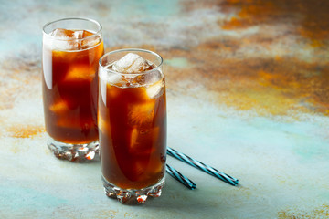 Ice coffee in a tall glass with cream