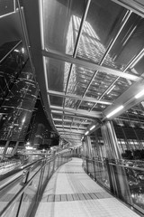 Modern pedestrian walkway in downtown of Hong Kong city at night