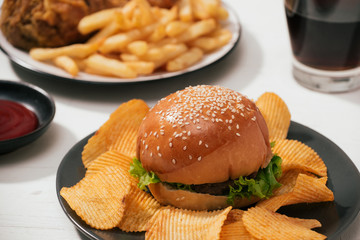 Fast food hamburger with set fried crispy chicken and french fries, ice cola on the side