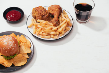 Fast food hamburger with set fried crispy chicken and french fries, ice cola on the side