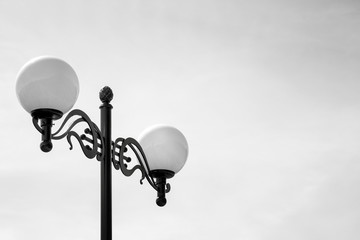 Two Street Lamps on Black Lamp Stand. Black and White Photo. Minimal Details. - 258838696