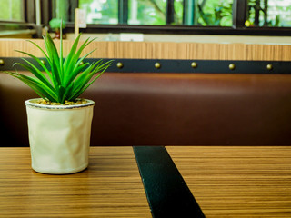 The small flowerpot on the wood table. Background with copy space.