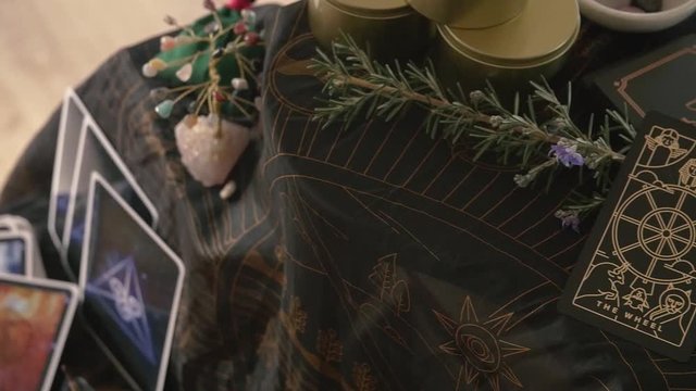 Slow pan across altar with stacked tarot deck and gemstone tree