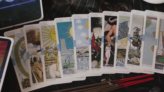 Slow pan across tarot cards and incense sticks